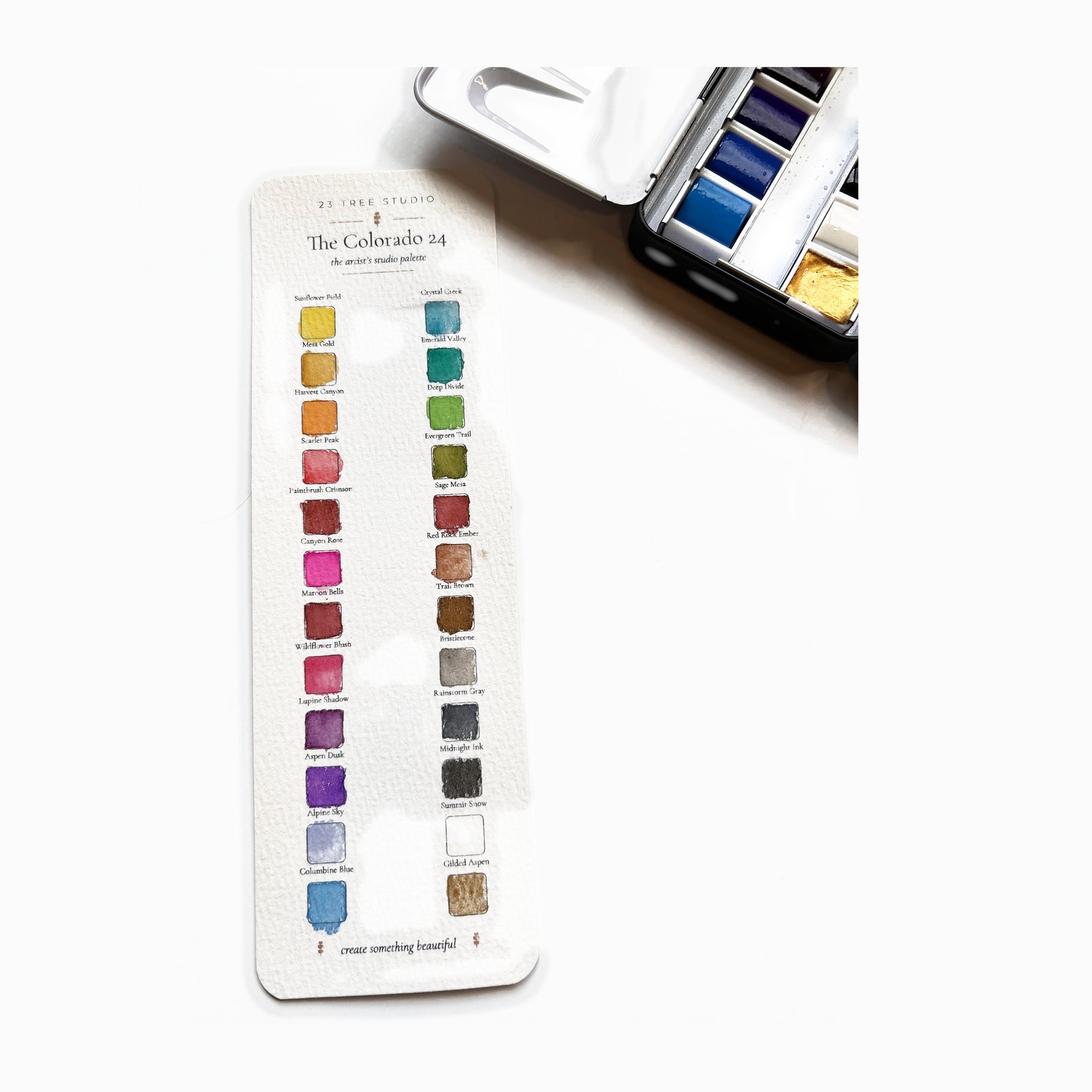 The Colorado 24 hand-painted swatch card beside the open tin