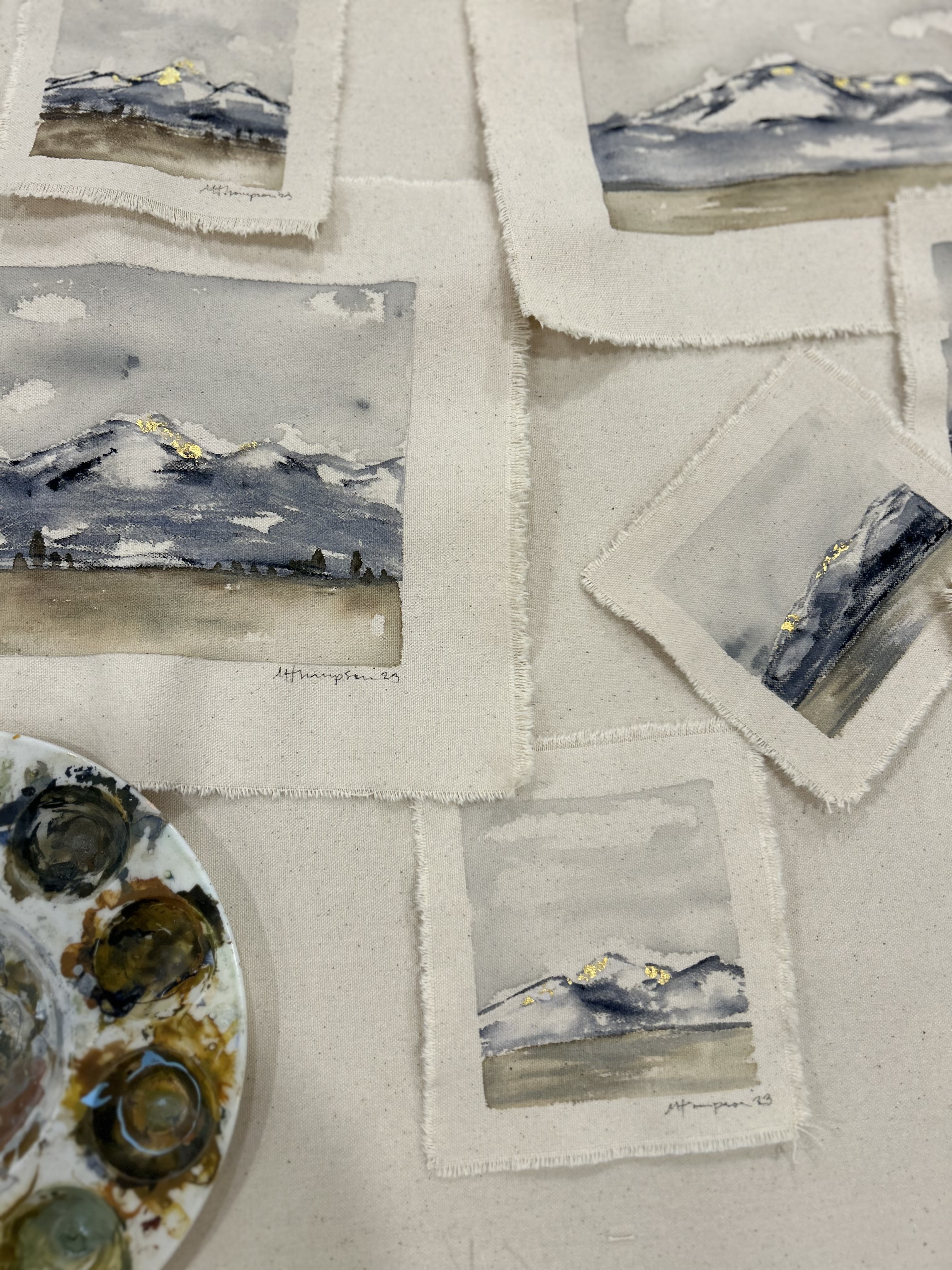 Tiny watercolor mountain landscapes in progress alongside my palette