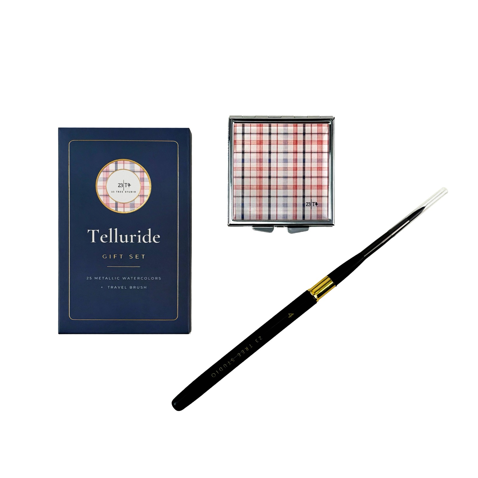 Telluride gift set — navy box, plaid shimmer compact, and travel brush