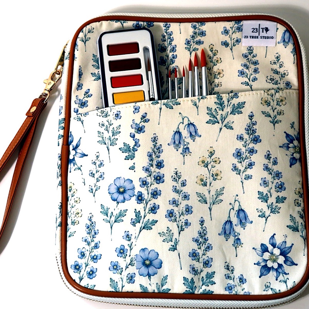 Wildflower-print watercolor clutch with paint set and brushes in the front pocket